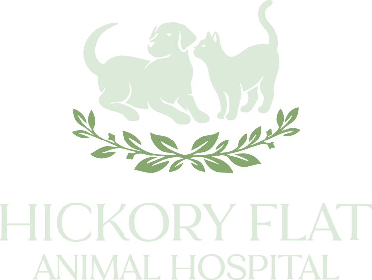 Light green silhouettes of a dog and cat stand above a leafy green branch. Below them, the text reads Hickory Flat Animal Hospital in large, light green letters.